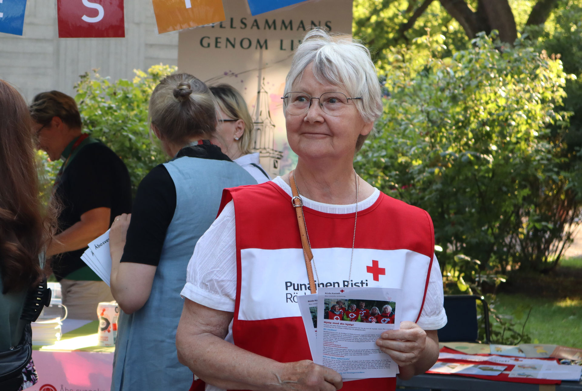 Monica Nerdrum, vapaaehtoinen Turun ruotsinkielisessä osastossa, jakaa osaston esitteitä Taiteiden Yönä Turussa.