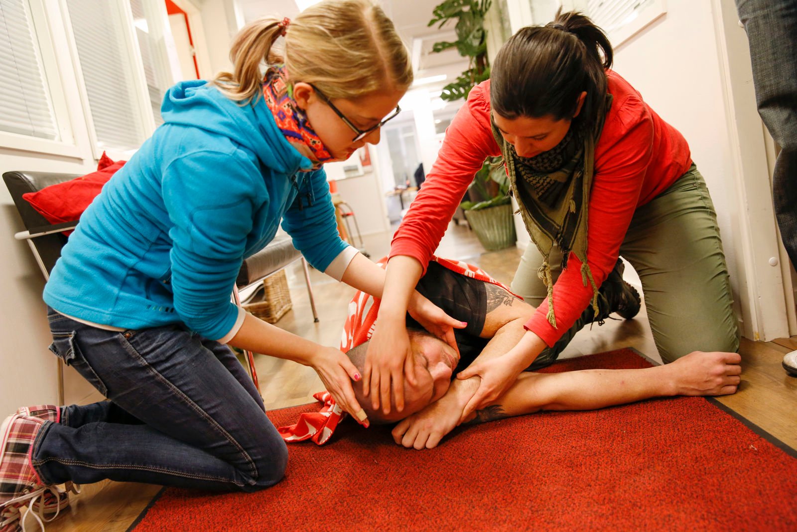 Kaksi ihmistä antamassa ensiapua.