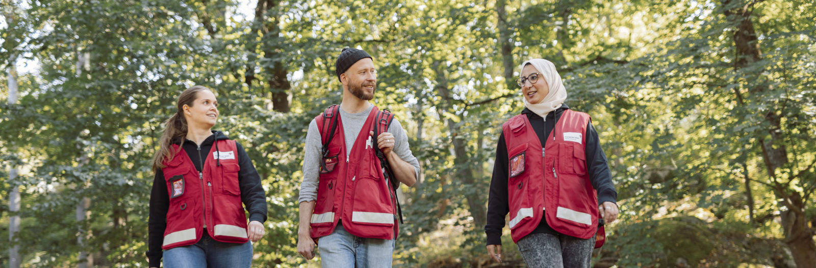  Three Red Cross volunteers walking outdoors